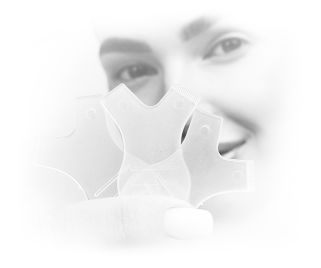 Grey picture of a woman holding Lifting Combs up to the camera